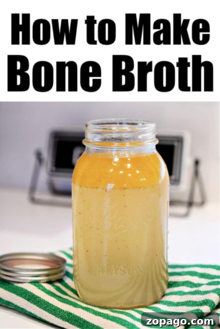 Effortless Instant Pot Bone Broth 7 Mason jar filled with golden bone broth on a striped cloth, ready for storage.