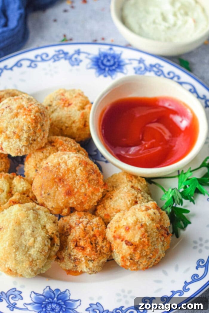 Crispy Air-Fried Mashed Potato Bites 2 Crispy air fryer mashed potato balls on a serving plate