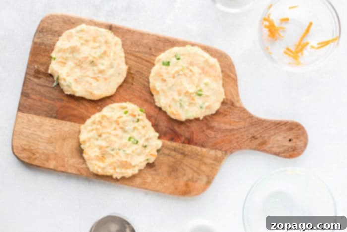 Crispy Air Fryer Potato Pancakes 5 A golden-brown air fryer potato pancake in the air fryer basket.