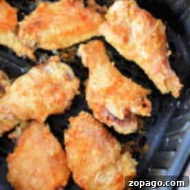 Crispy Air Fryer Chicken Wings with Baking Powder 7 Crispy Air Fryer Chicken Wings made with a touch of baking powder, perfectly cooked in an air fryer basket.