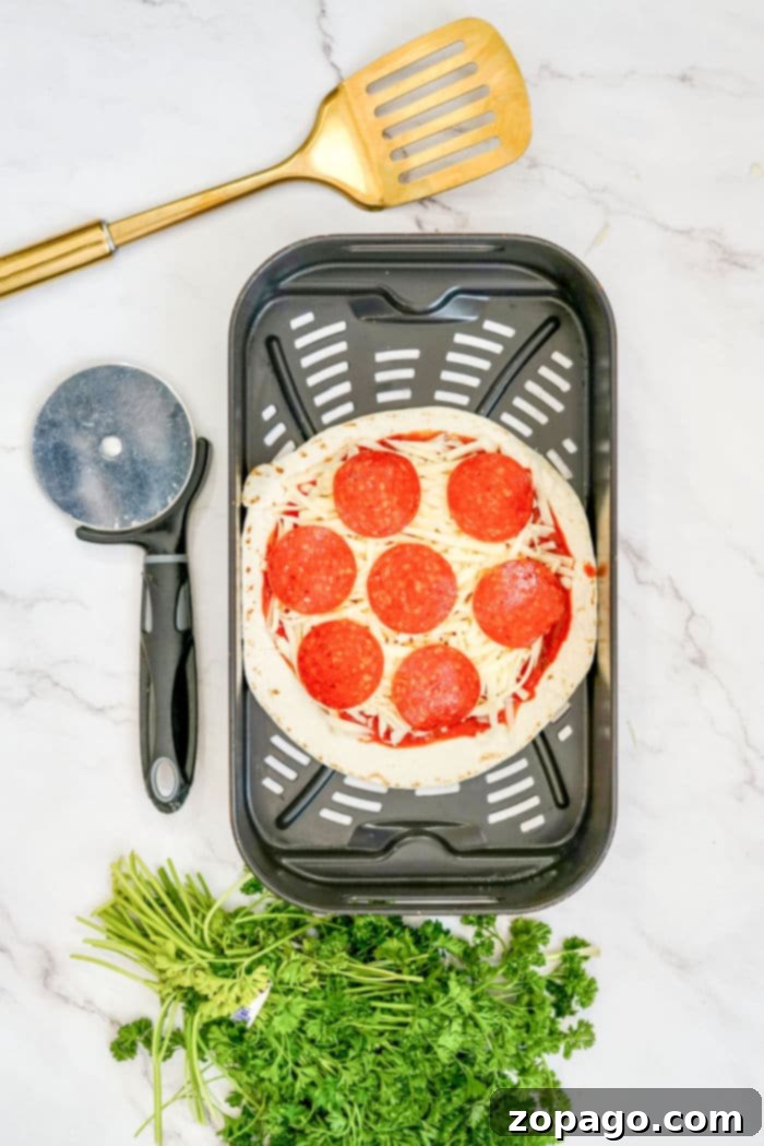 Effortless Air Fryer Tortilla Pizzas 5 Hands preparing a tortilla pizza with sauce, cheese, and pepperoni, illustrating the ease of assembly for homemade pizza.