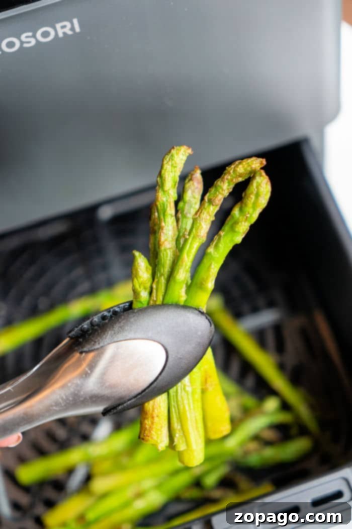 Easy Air Fryer Frozen Asparagus 2 Perfectly air-fried frozen asparagus spears, golden and crisp, ready to be served as a delicious side dish.