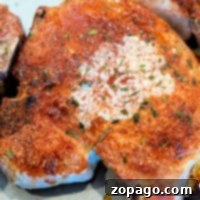 Learn how to cook 2-inch thick pork chops seasoned and baked on a baking sheet for a deliciously juicy experience.