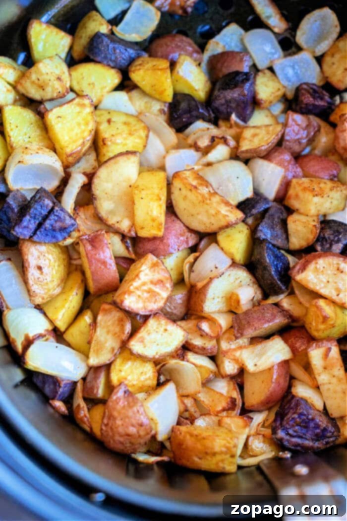 Savory Potato and Onion Medley 2 A close-up of mixed roasted potatoes with golden brown, purple, and white pieces, enhanced by the delightful addition of air fryer onions for extra flavor in air fryer.