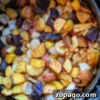 Savory Potato and Onion Medley 7 In the black air fryer basket, a medley of roasted potatoes and onions transforms into a savory delight, perfectly highlighting the charm of air fryer cooking.