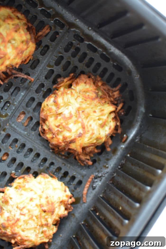 Golden Crispy Air Fryer Latkes 6 A serving of Ninja Foodi latkes with sour cream and chives