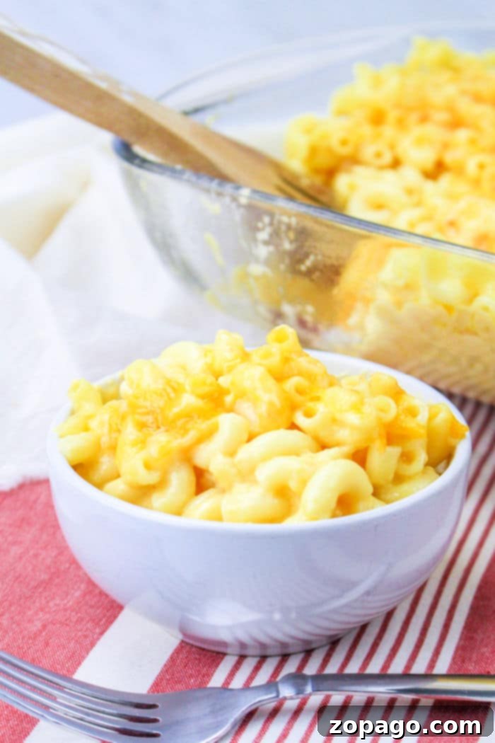 Signature Chick-fil-A Mac and Cheese 2 A golden-brown baked mac and cheese, reminiscent of Chick-fil-A's popular side, in a glass baking dish, ready to be served.