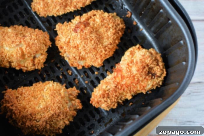 Crispy Gluten-Free Air Fryer Chicken Wings 9 A close-up of several air-fried gluten-free chicken wings on a plate, showcasing their perfect golden-brown color and crispy texture.