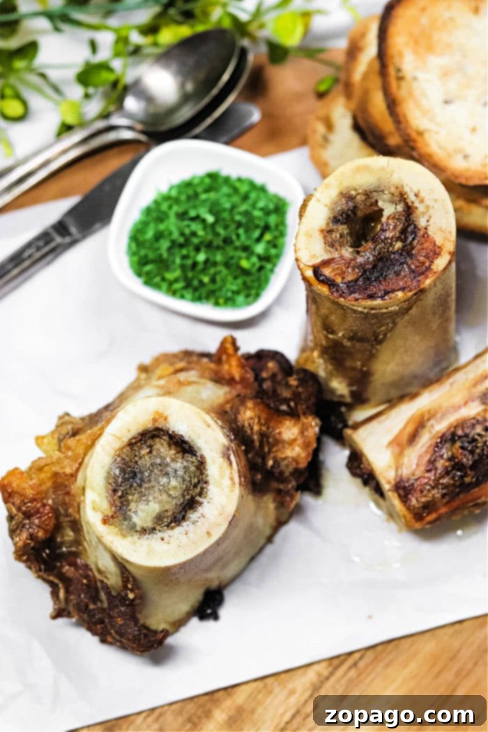 Unlocking the Delights of Bone Marrow 2 Perfectly cooked bone marrow glistening on a baking sheet, ready to be scooped.