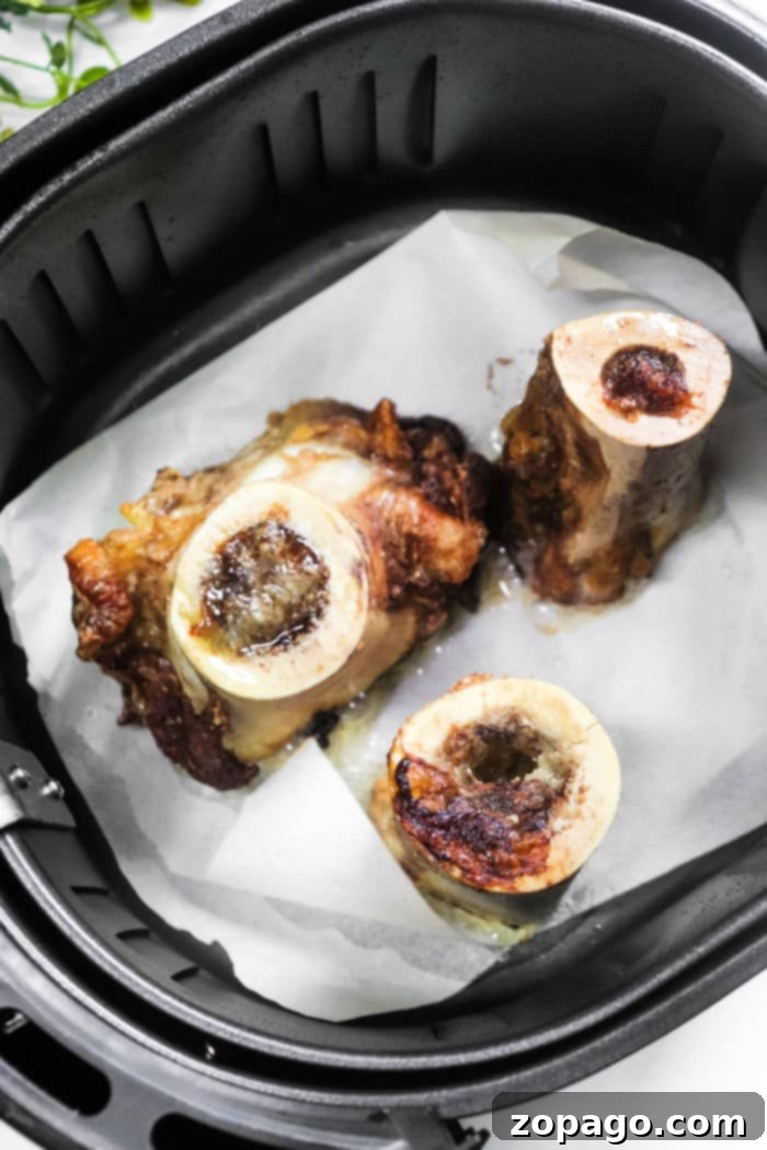 Unlocking the Delights of Bone Marrow 6 Air fryer basket filled with perfectly cooked bone marrow, highlighting its golden-brown crust.