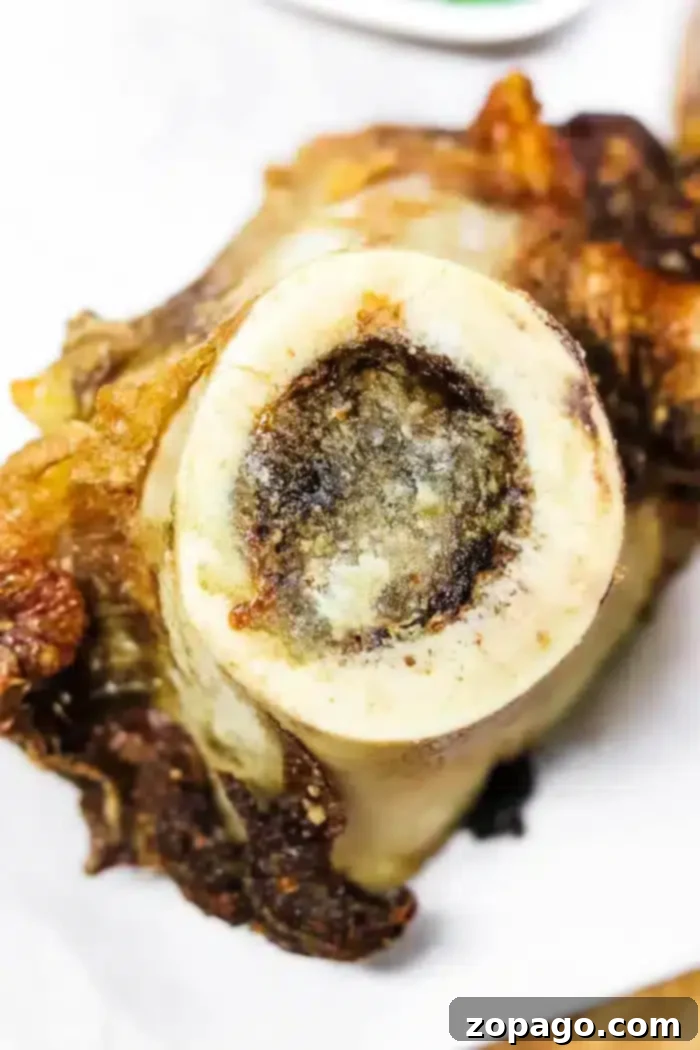 Air Fryer Roasted Bone Marrow 6 Close-up of a perfectly roasted bone, revealing tender bone marrow at its center, with crispy edges from air frying.