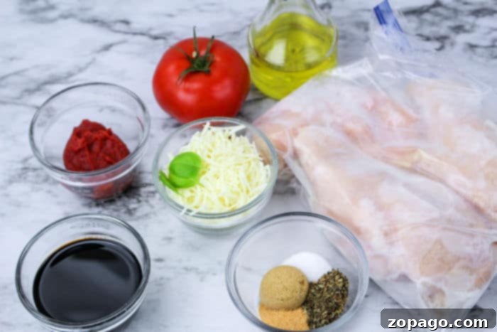No Thaw Slow Cooker Chicken Breasts 3 Chicken Caprese with frozen chicken, showcasing a vibrant sauce and fresh ingredients.