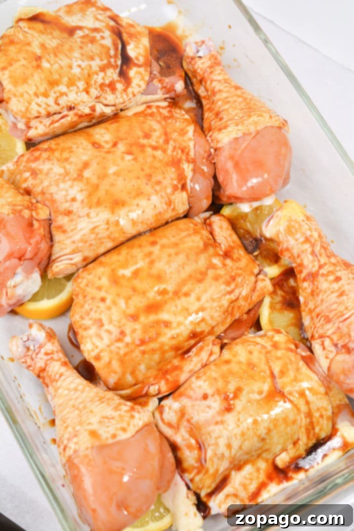 Sticky Teriyaki Baked Chicken 4 An overhead shot of a baking dish filled with baked teriyaki chicken, garnished and ready to serve.