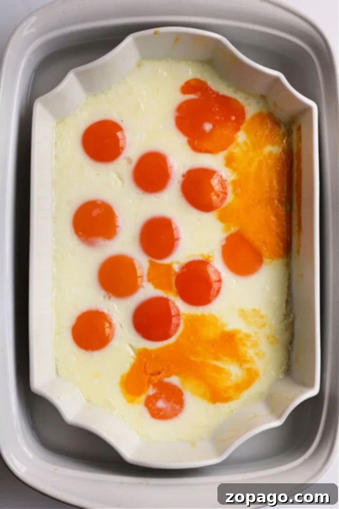Effortless Peel-Free Hard-Boiled Eggs 4 Baked eggs in a dish with vibrant yolks evenly distributed across the surface, resembling perfectly cooked no peel hard boiled eggs.