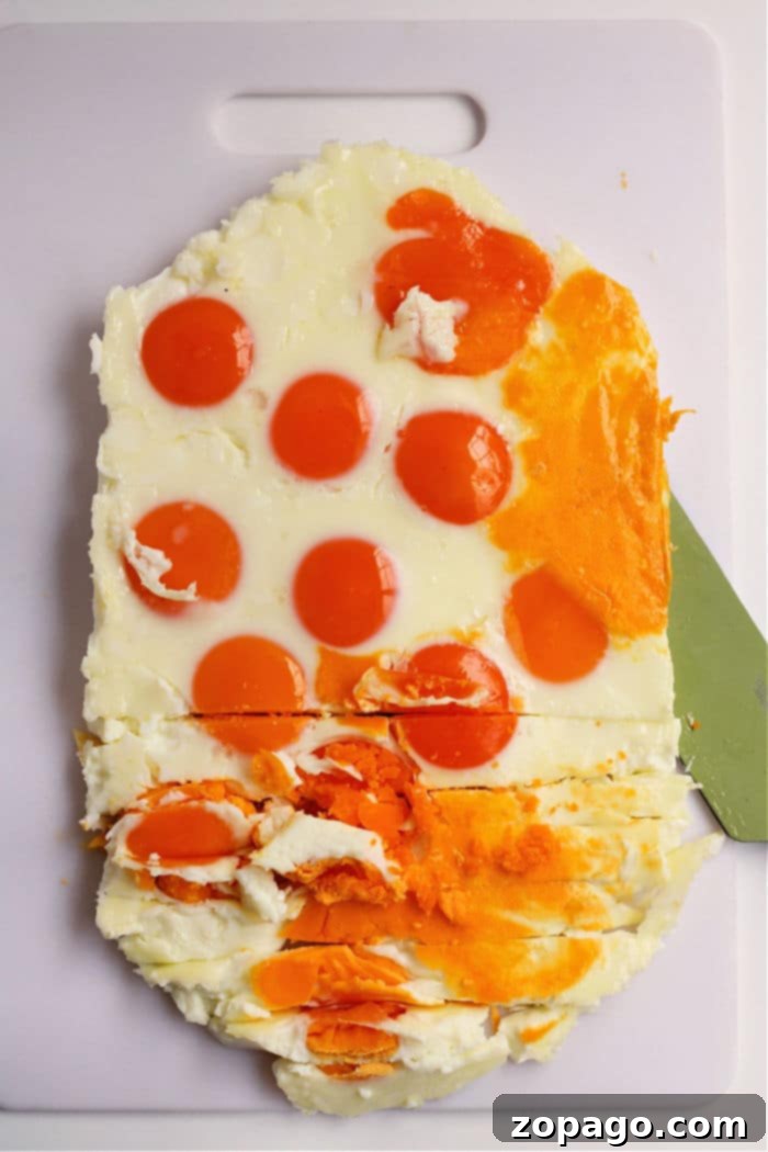 Effortless Peel-Free Hard-Boiled Eggs 5 A golden hard-boiled egg loaf sits in a baking dish, freshly removed from the oven, symbolizing a new era of effortless egg preparation.