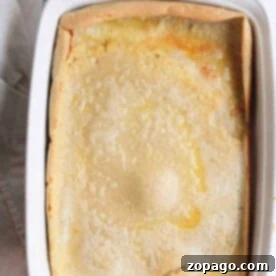 Oven-Baked Pancakes 7 Baked in the oven, this Dutch baby pancake rests perfectly in a white rectangular dish on a wire rack.