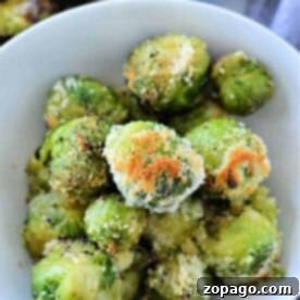 Cooking Frozen Brussels Sprouts Perfectly 7 A bowl of perfectly roasted Brussels sprouts, skillfully transformed from their frozen state, is topped with golden breadcrumbs and flavorful seasoning.