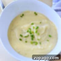 Creamy Instant Pot Potato Leek Soup 8 A bowl of creamy mashed potatoes topped with chopped chives brings the comforting essence of an Instant Pot Potato Leek Soup to your table.