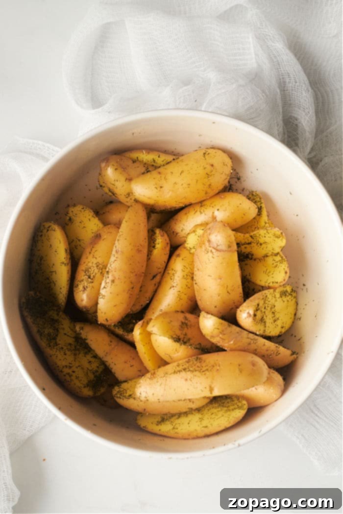 Crispy Air Fryer Fingerling Potatoes 4 How to Cook Fingerling Potatoes - A serving of beautifully air-fried fingerling potatoes, ready to be enjoyed, garnished with fresh dill.