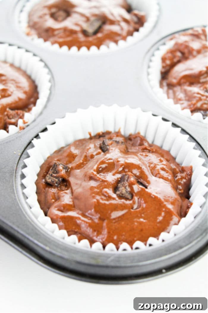 Homemade Giant Costco Chocolate Muffins 4 Freshly baked Copycat Costco Muffins, showcasing their golden-brown tops and generous size.