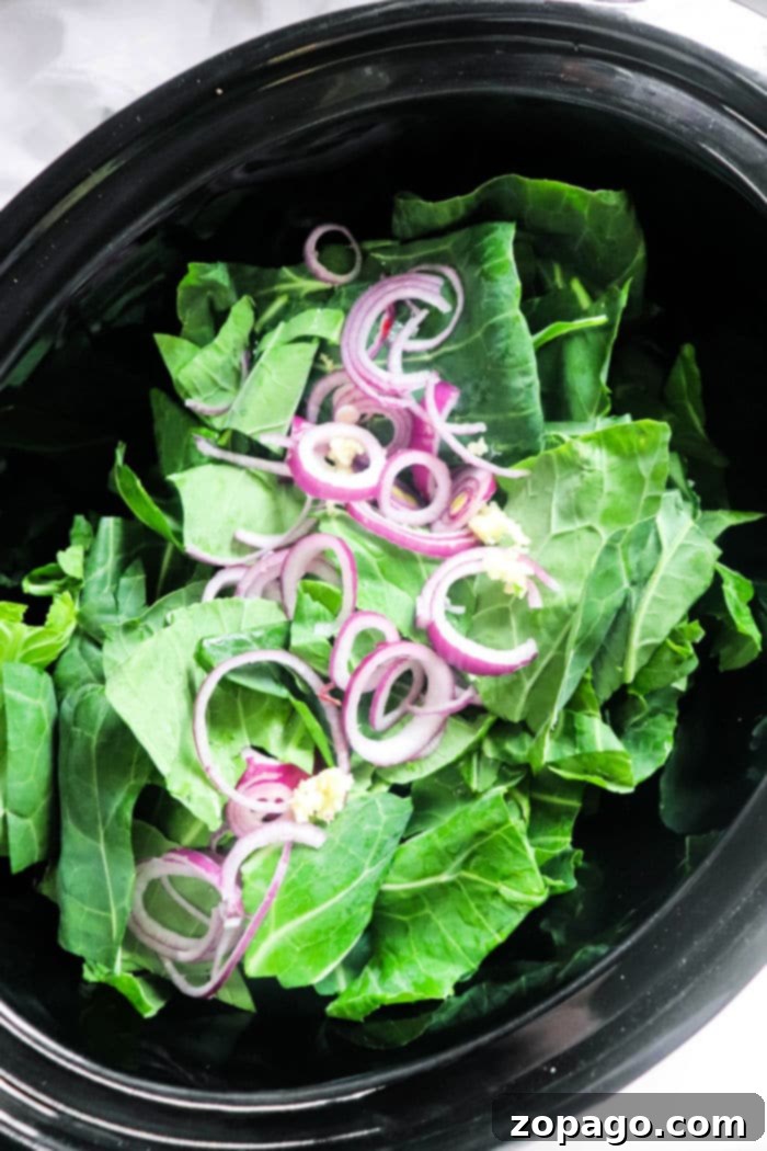 Close-up of Crockpot Collard Greens, showcasing the tender greens simmered in a rich broth with visible ham hocks.