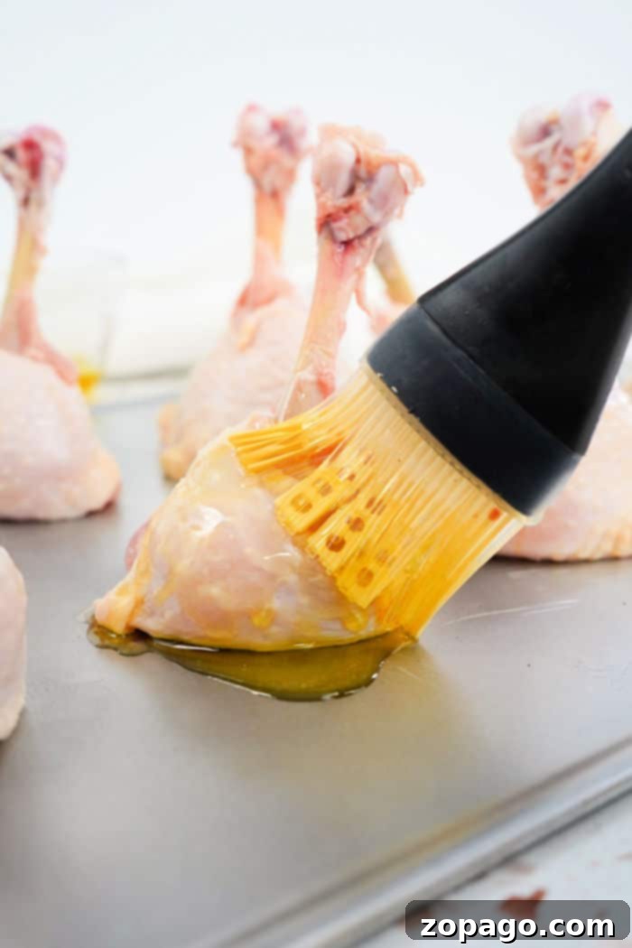 Delicious Lollipop Chicken Drumsticks Recipe 9 Preparing chicken drumsticks for lollipopping on a cutting board, highlighting the technique.