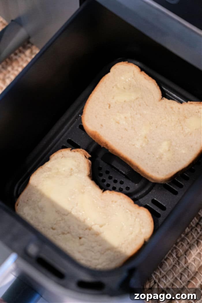 Perfect Air Fryer Toast 6 A slice of toast being carefully removed from a Ninja Foodi air fryer