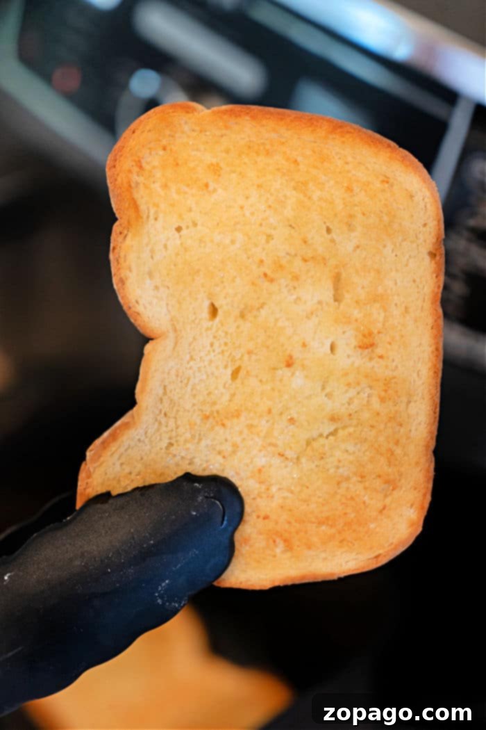 Perfect Air Fryer Toast 7 A stack of perfectly golden air fryer toast, invitingly placed