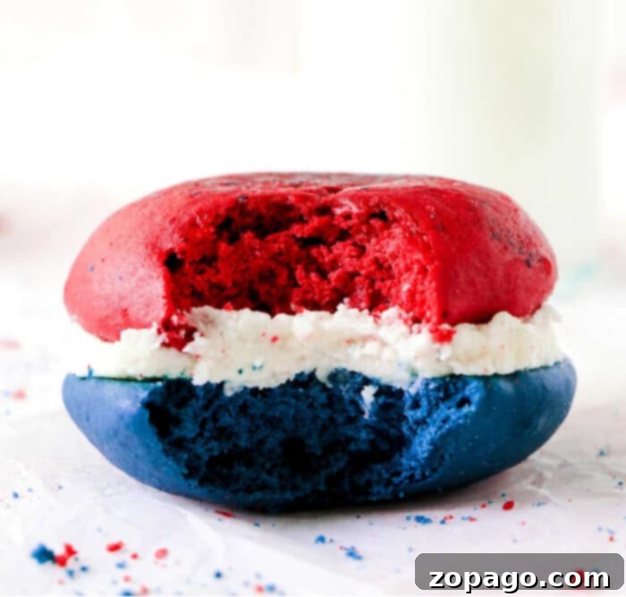 Easy Cake Mix Whoopie Pies 2 A vibrant red, white, and blue cake mix whoopie pie, with a bite taken, revealing its moist layers and creamy white filling. It evokes a sense of sweet nostalgia, perfect for a celebration.