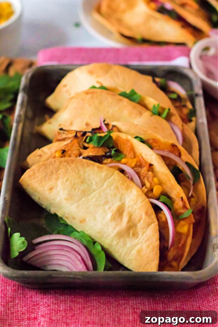 Crispy Air Fryer Tacos 2 Air Fryer Tacos, beautifully crispy and golden brown, filled with a hearty mixture.