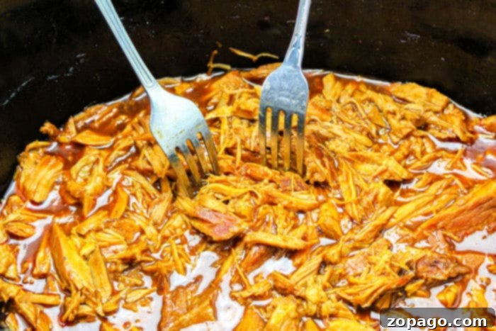 Savory Pulled Pork Baked Potato 5 Slow cooker filled with pulled pork and potatoes, cooking to perfection.