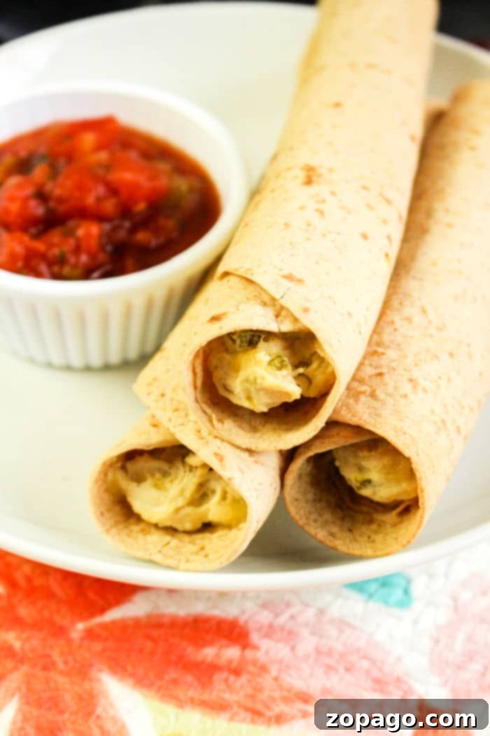 Homemade Crispy Air Fryer Chicken Taquitos 7 Platter of golden crispy Air Fryer Chicken Taquitos with various dips