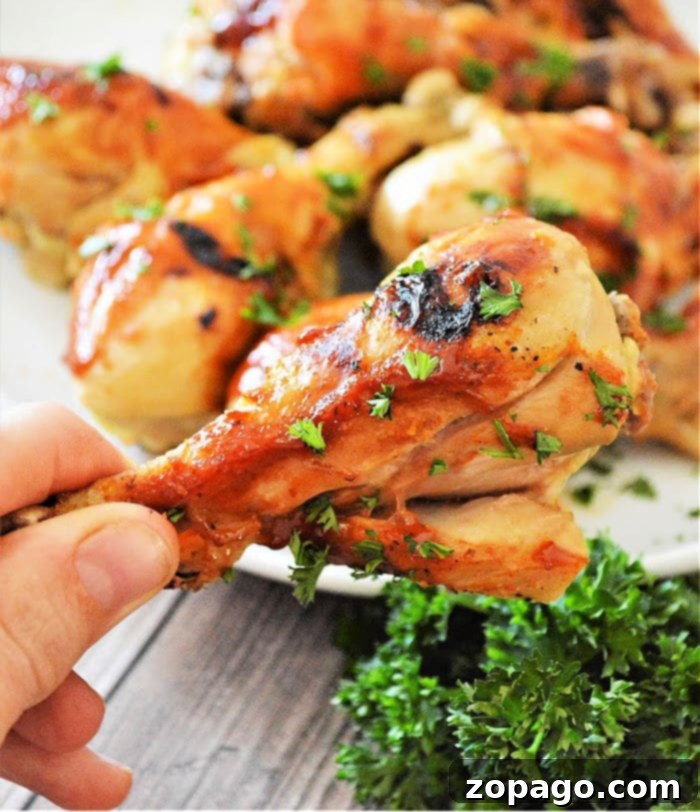 Close-up of a perfectly cooked air fryer frozen chicken leg with visible crispy skin and tender meat.
