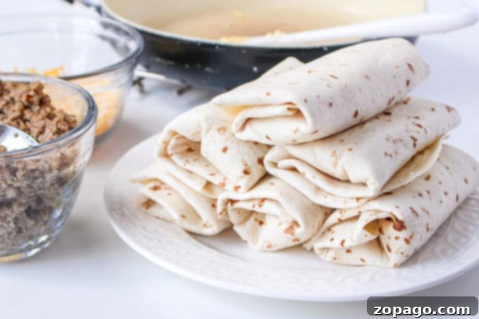 Crispy Ninja Foodi Air Fryer Breakfast Burritos 7 A freshly cooked breakfast burrito in an air fryer basket, showing its golden-brown exterior