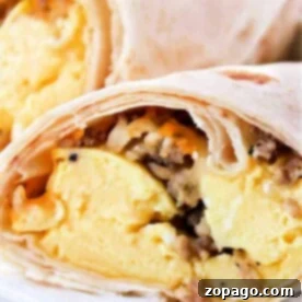 Crispy Ninja Foodi Air Fryer Breakfast Burritos 9 Close-up of breakfast burritos, perfectly cooked in an air fryer, filled with scrambled eggs and sausage.