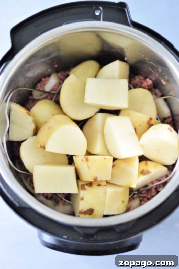 Instant Pot Shepherd's Pie 4 Shepherd's Pie cooking in a pressure cooker with mashed potato topping