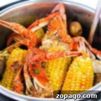 Crabs, corn, and potatoes simmering in an Instant Pot, seasoned to perfection and ready to serve.