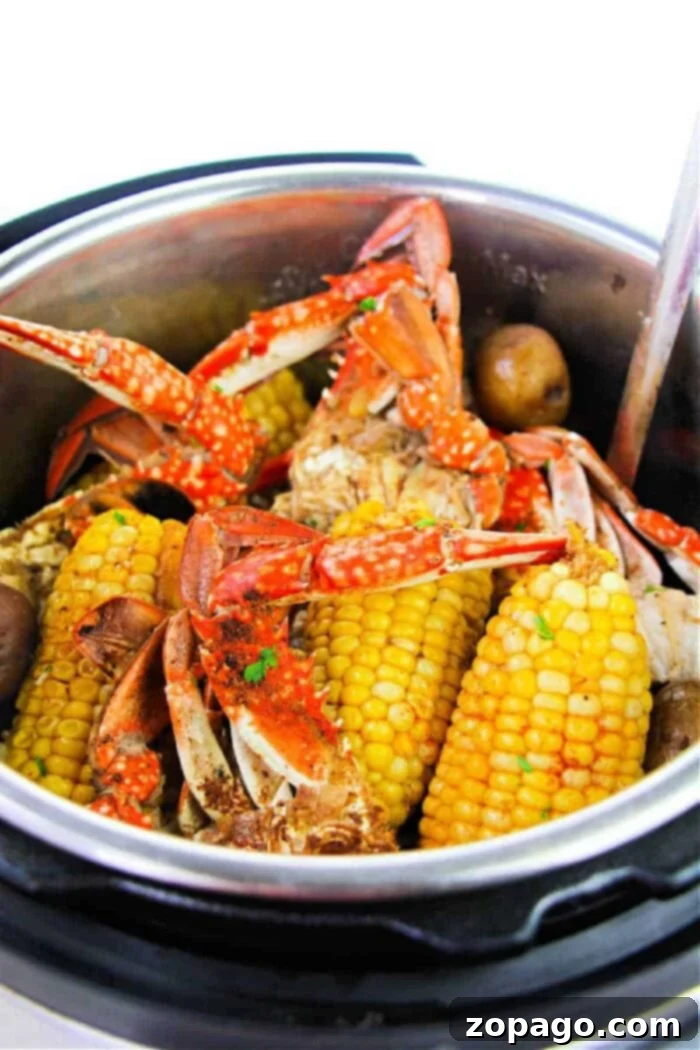 Pressure cooker crab boil featuring a bountiful mix of crab, corn, and potatoes