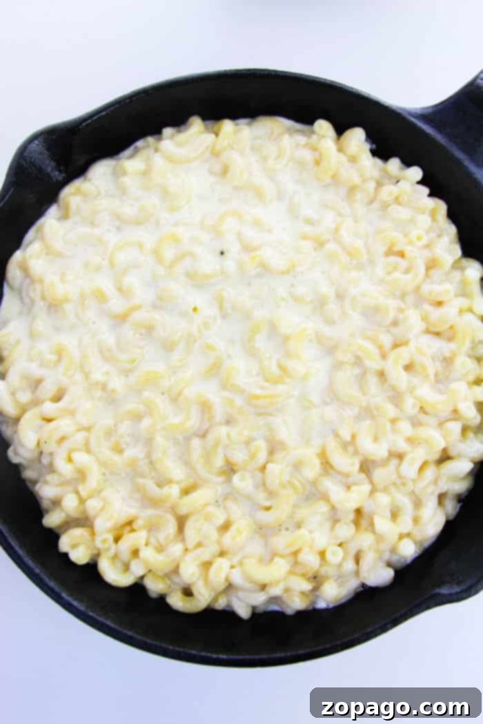 One-Pan Pepperoni Pizza Mac 4 Cast iron skillet filled with mac and cheese, ready for the oven