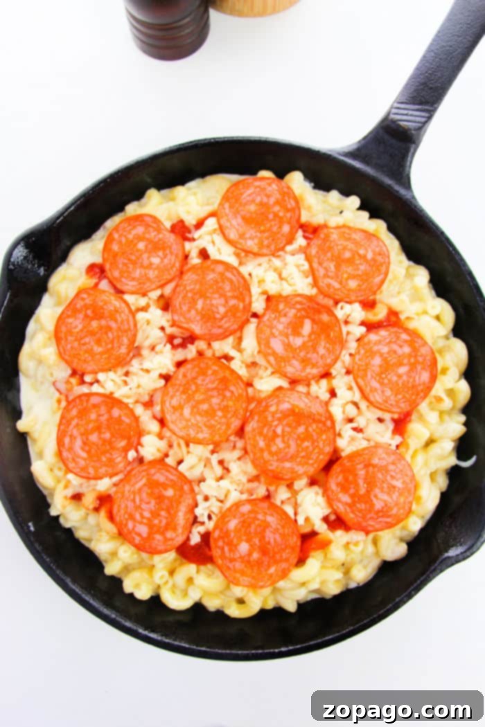 One-Pan Pepperoni Pizza Mac 5 Pepperoni Mac and Cheese topped with fresh herbs in a serving dish