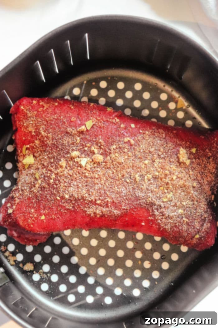 Perfectly Tender Air Fryer Brisket 5 Juicy air fryer beef brisket, perfectly seasoned and seared, ready for the next cooking phase.