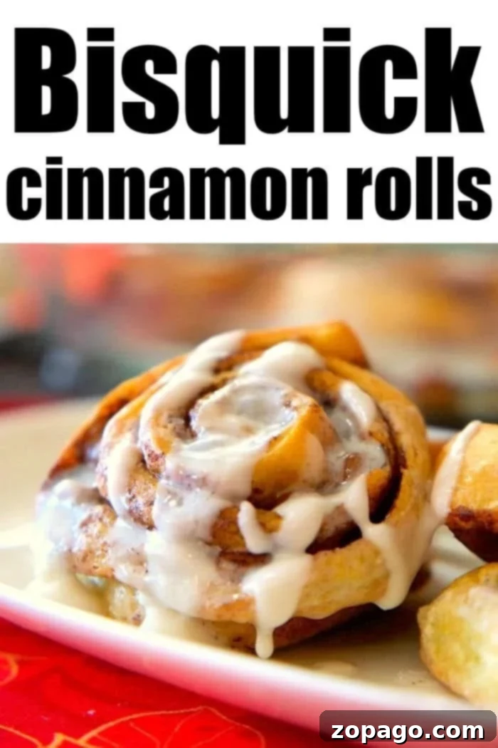 Effortless Bisquick Cinnamon Rolls 9 Plate of glazed Bisquick Cinnamon Rolls with a fork.