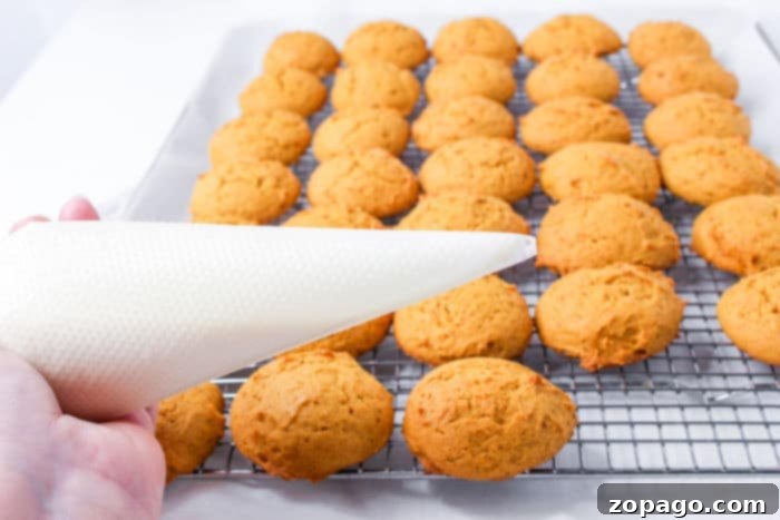 Glazed Pumpkin Spice Cookies 5 Close-up of soft iced pumpkin cookies on a cooling rack, showcasing their texture and inviting appearance.
