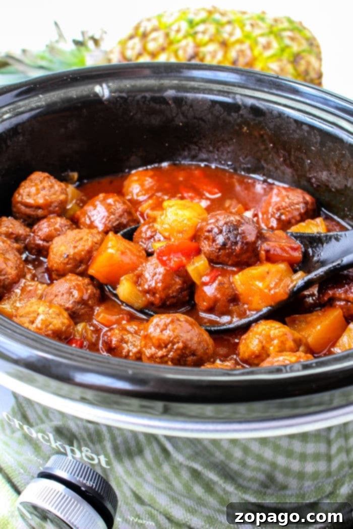 Effortless BBQ Meatballs 2 Slow Cooker BBQ Meatballs simmering in a Crockpot, showcasing their rich, savory glaze.