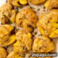 Crispy smashed potatoes with herbs and seasoning, fresh out of the air fryer.