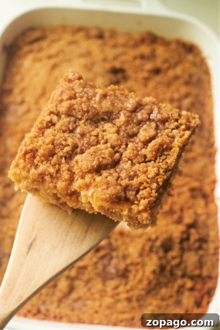 A generous slice of banana bread coffee cake on a rustic wooden board, ready to be enjoyed.