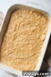 Banana coffee cake batter in a white baking dish, ready to be baked.