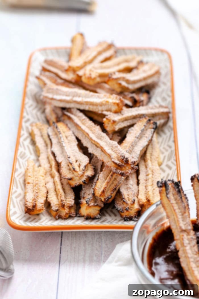 Air Fryer Chocolate Churro Delights 2 Filled Churros, golden brown and perfectly crispy, ready to be enjoyed.