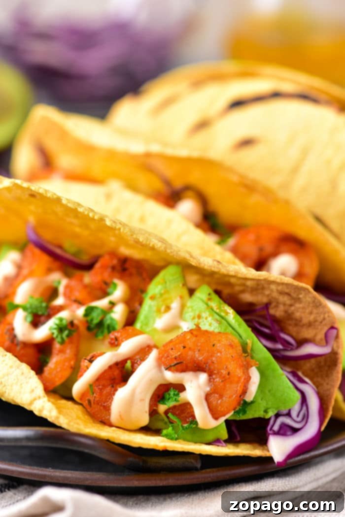 Easy Shrimp Tacos Recipe with Coleslaw and fresh toppings.