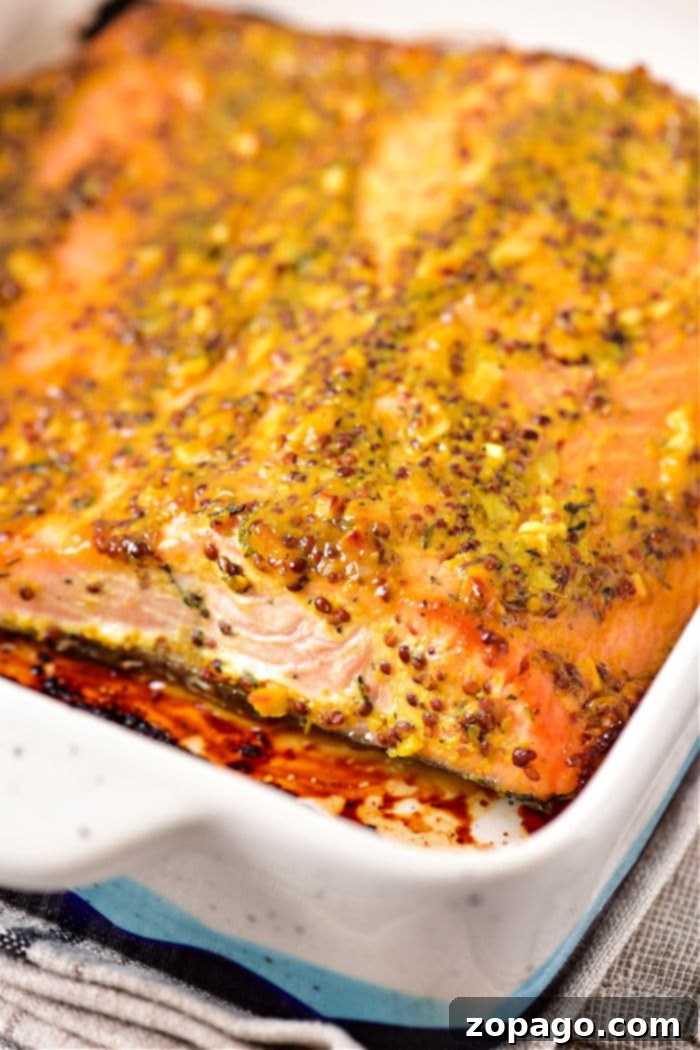 Golden Honey Mustard Salmon 5 Baked salmon fillet topped with a mustard sauce and herb crust in a rectangular dish.